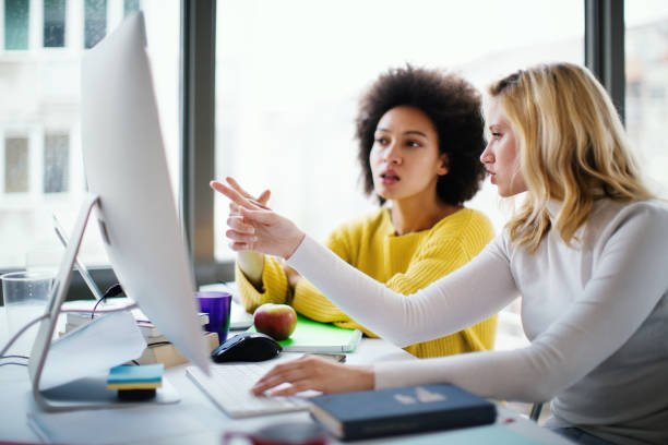 programmers working together on a computer code. programmers working together on a computer code.